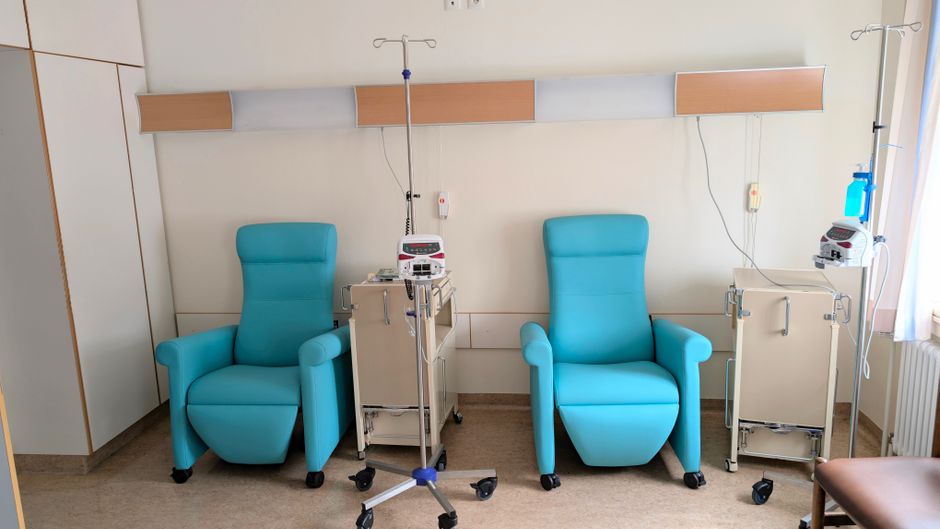 Calm hospital room featuring infusion chairs and equipment for chemotherapy treatment.