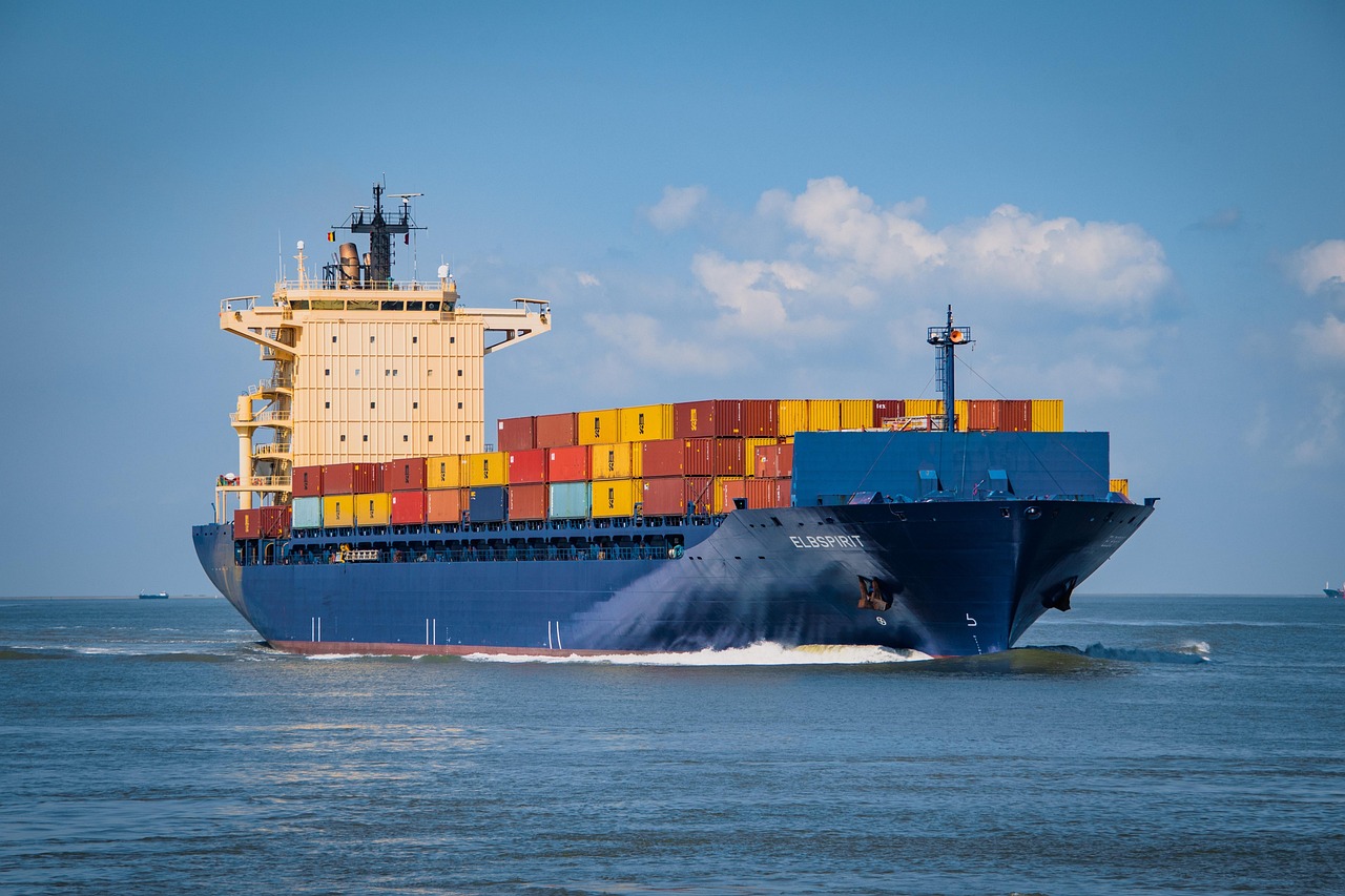 container ship in Strait of Hormuz with military escort