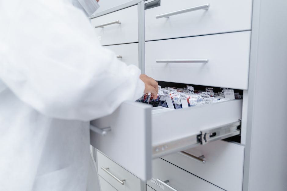 A healthcare professional accesses medical files in a sterile laboratory setting.