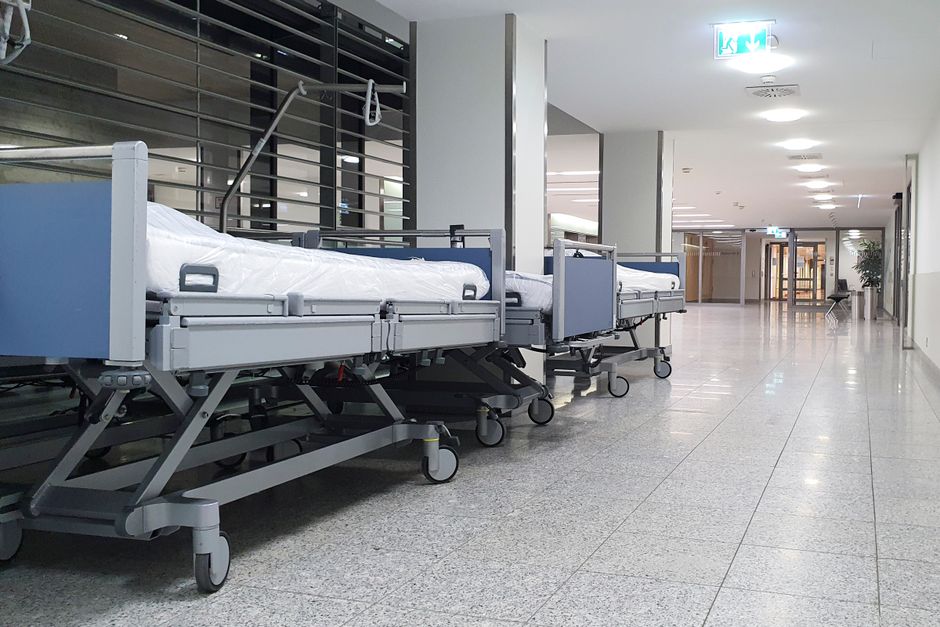 Healthcare furniture being installed in a hospital corridor with protective film on surfaces