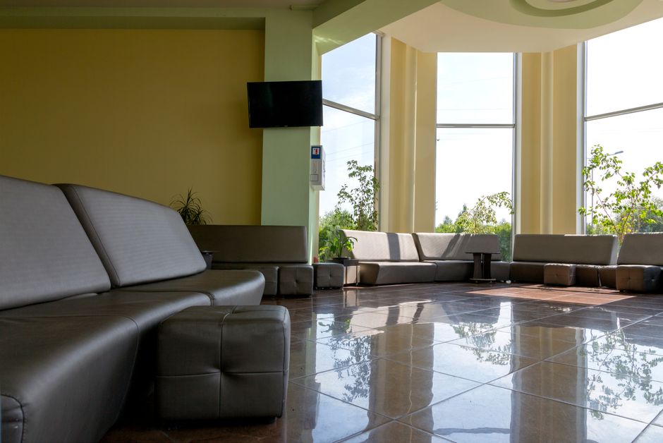 Hospital discharge lounge with comfortable recliners and accessible tables, designed for patient comfort