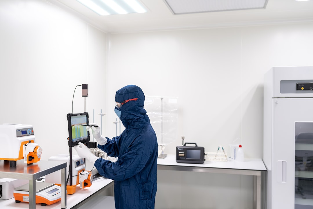 Test engineer inspecting a hospital bed in a laboratory for IEC 80601-2-52 compliance