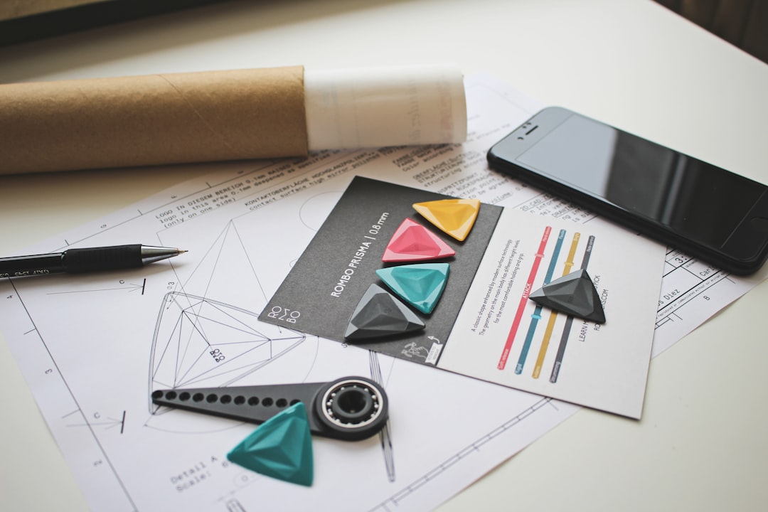 Hospital furniture requirements document open on a desk beside a wood-based panel sample and a digital caliper