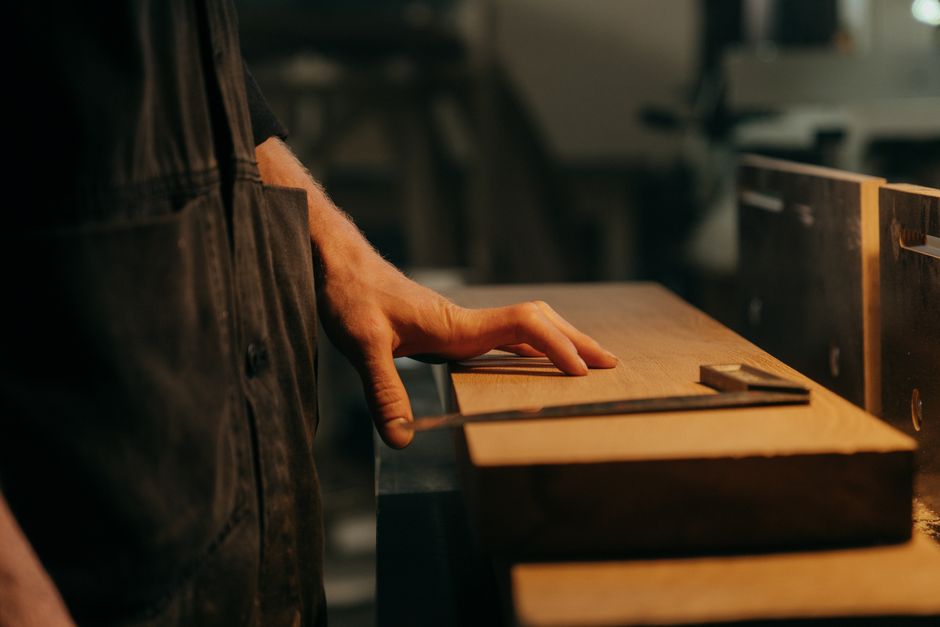 Laboratory technician testing a medical wood-based panel sample for antibacterial performance in an accredited lab